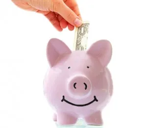 smiling pink piggy bank with hand saving money