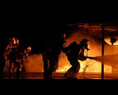 US Marine Corps (USMC) Fire Fighters assigned to Aircraft Rescue and Fire-Fighting (ARFF), train to extinguish fires inside the mock aircraft fire pit, aboard Marine Corps Air Station Beaufort, South Carolina (SC). (USMC PHOTO BY LCPL EDWARD BROWN 050217-M-2697B-020)