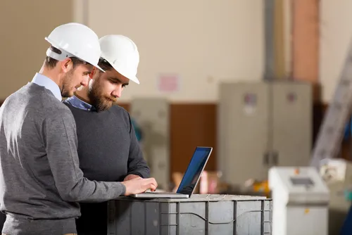 Warehouse workers and laptop