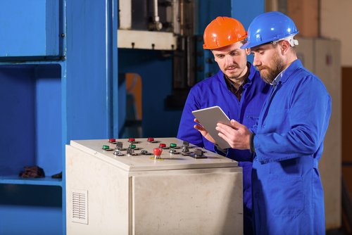 Workers at control panel