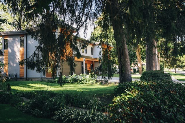 A big house surrounded by trees in the yard