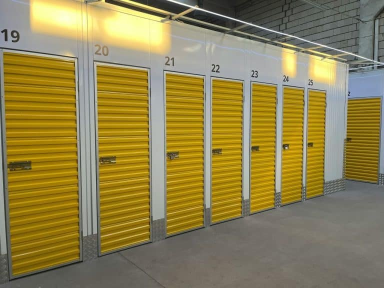 A row of storage units with yellow doors.