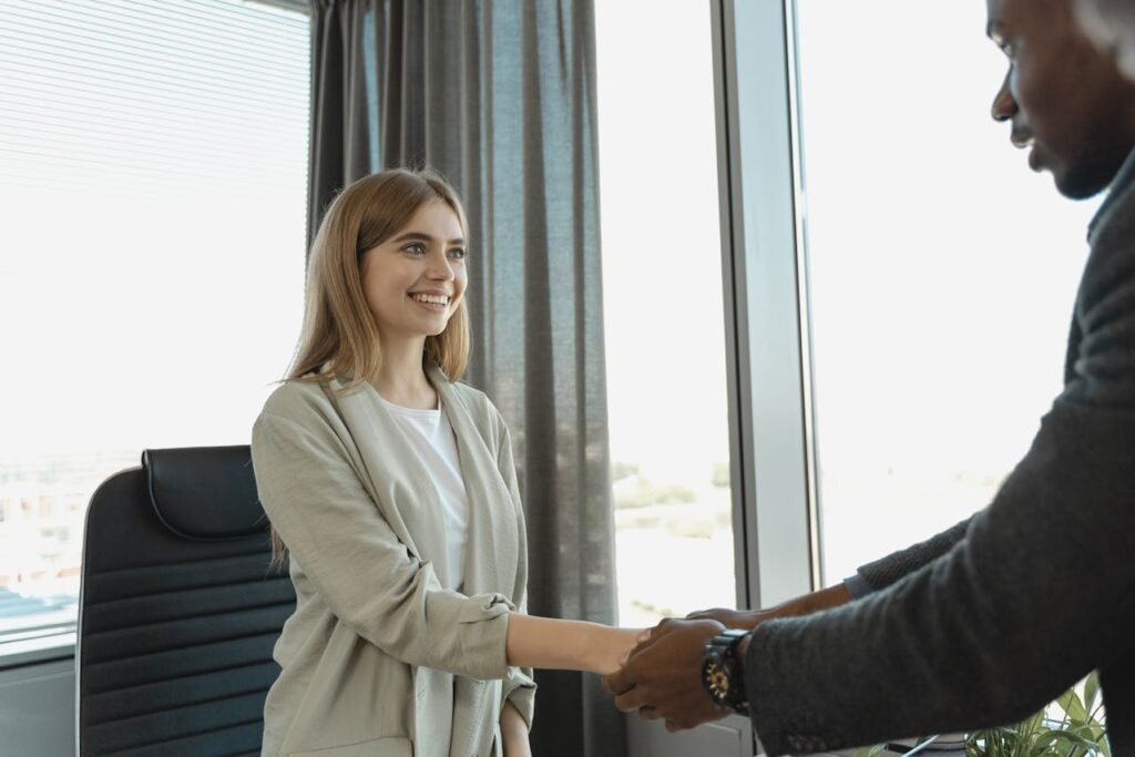 Woman shaking hands after a job interview.